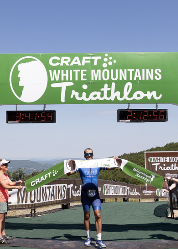 Breno Melo breaking the tape to win the Craft White Mountains Triathlon overall