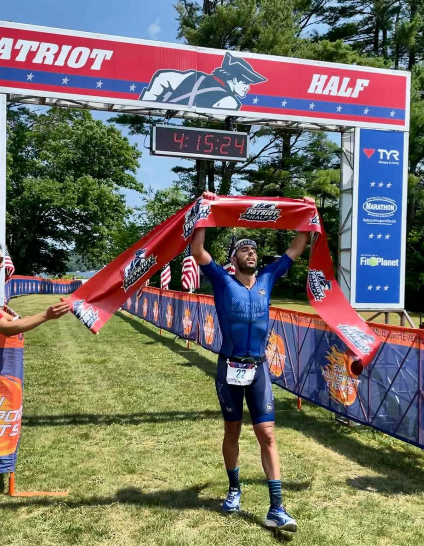 Breno Melo crossing the finish line first at the Patriot Half triathlon in Massachusetts